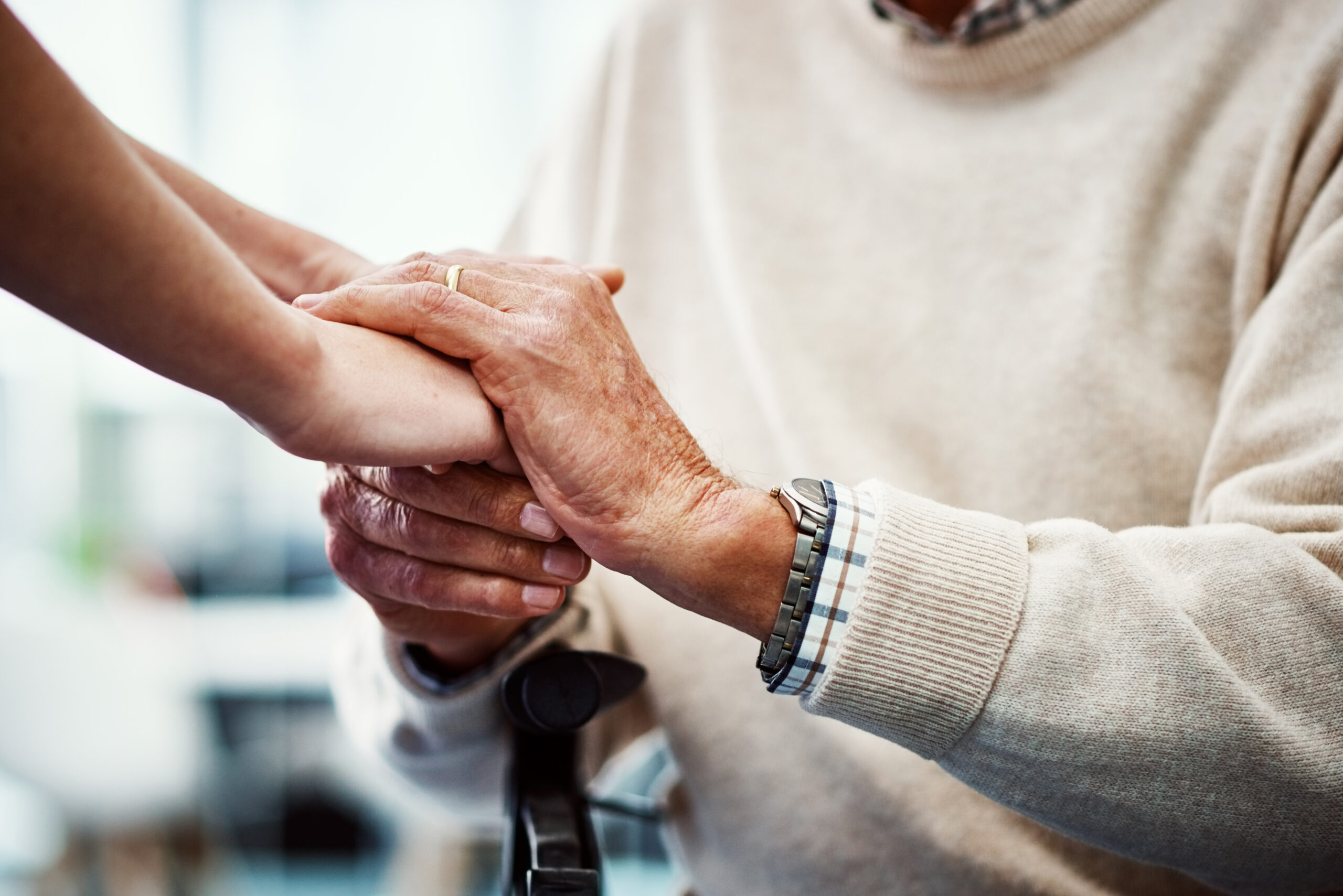 Cropped shot of an unrecognizable female nurse holding her senior patient's hand in comfort