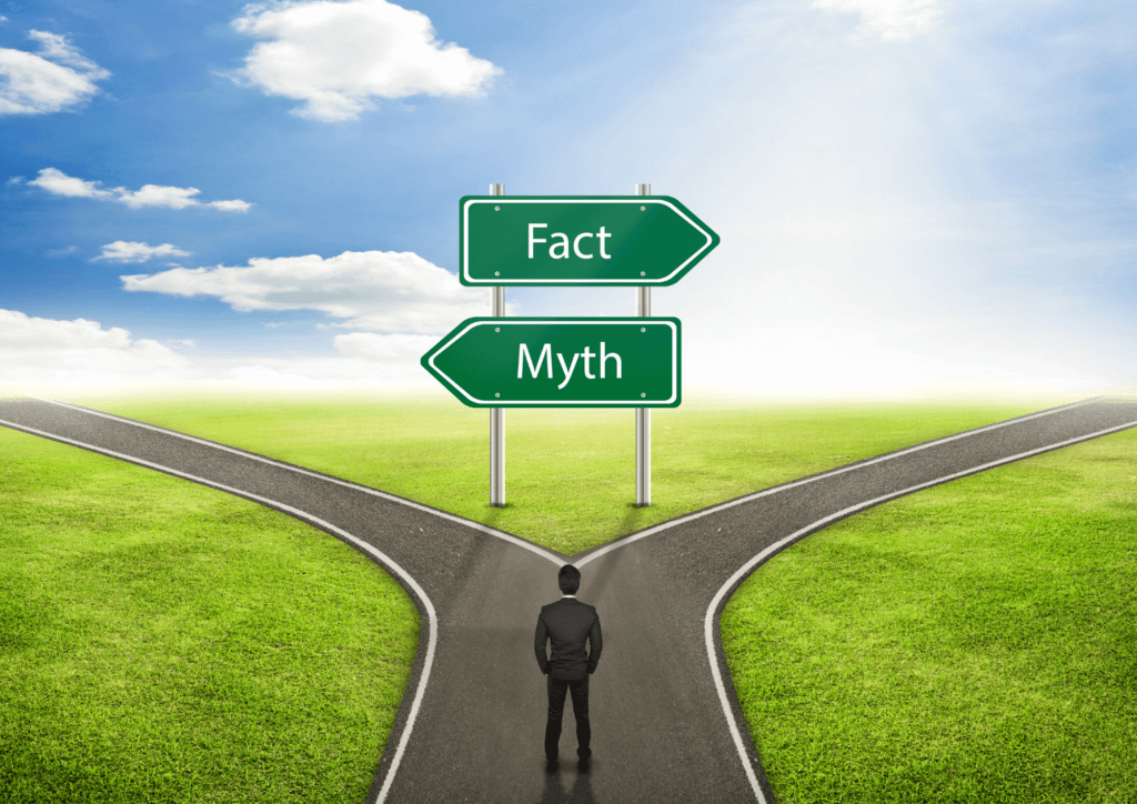 man standing before a sign with two arrows myth and fact