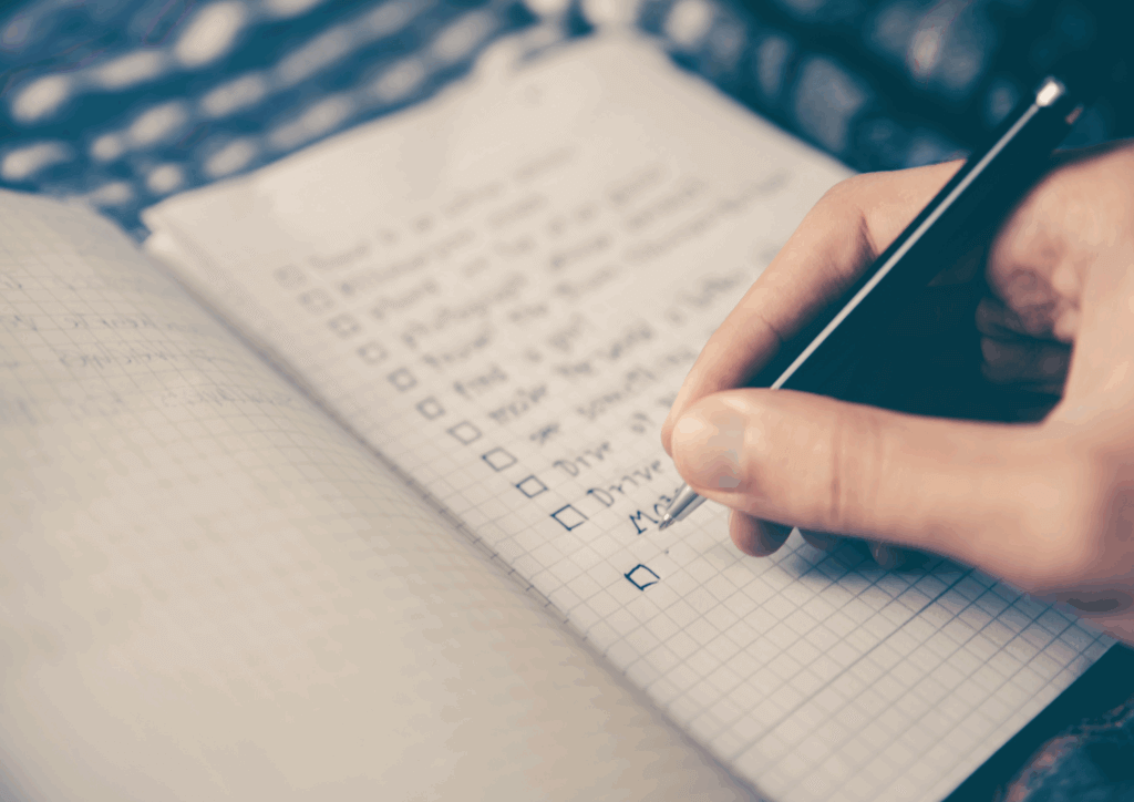 Hand writing a list of goal